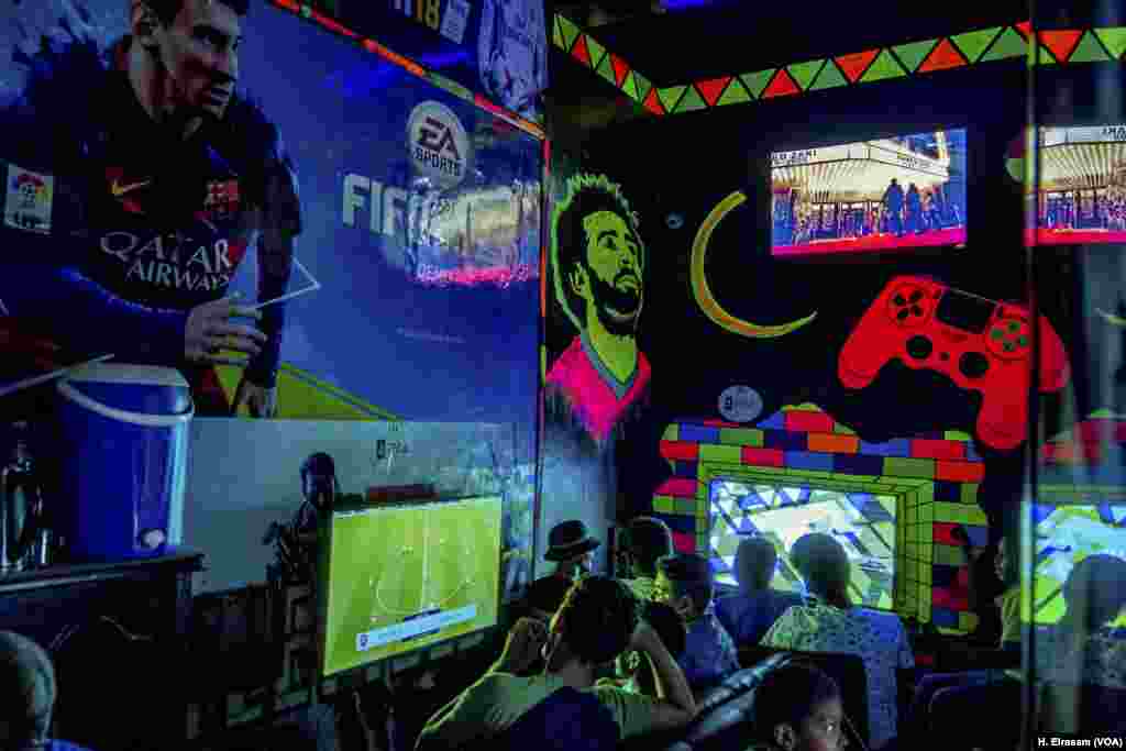 In a video game store, Mohamed Salah&rsquo;s face shines as young men.