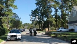Police patrol the area of a fatal shooting in Florence, S.C., Oct. 4, 2018. Frederick Hopkins, a Vietnam veteran who bragged online about maintaining his target-shooting skills has been charged in the shooting of multiple law enforcement officers.