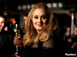 FILE - Singer Adele, winner of the Oscar for best original song for "Skyfall," is interviewed at the Governors Ball for the 85th Academy Awards in Hollywood, California.