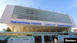 People arrive at the newly rebuilt National Theater, to watch the first film festival held in the capital of Mogadishu, Somalia, Sept. 22, 2021