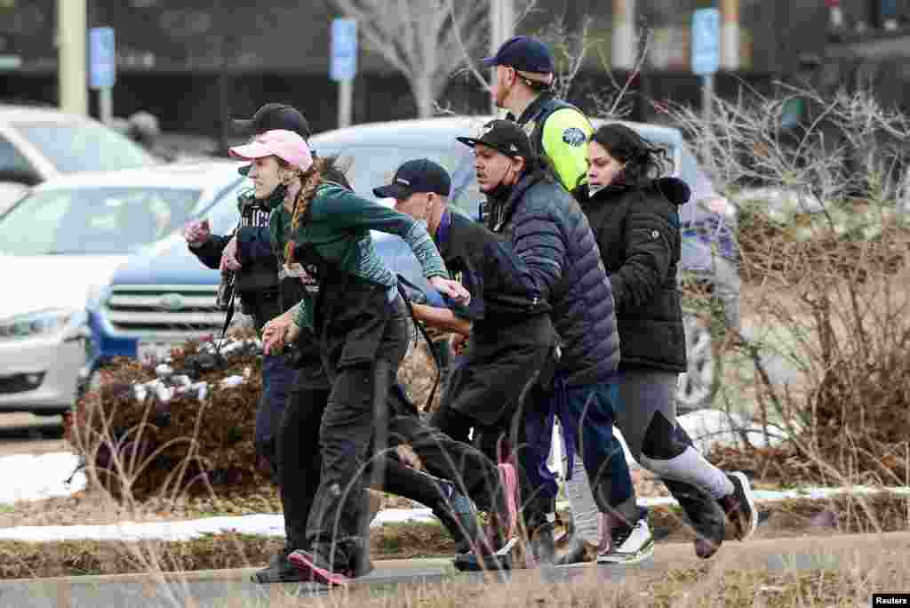 King Soopers employees are led away from an active shooter at the King Soopers grocery store in Boulder, Colorado, March 22. 2021. Police say 10 people were killed in the shooting. (Michael Ciaglo/USA TODAY NETWORK)