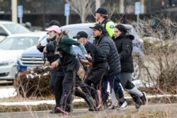 King Soopers employees are led away from an active shooter at the King Soopers grocery store in Boulder, Colorado, U.S. March 22. 2021.