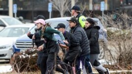 King Soopers employees are led away from an active shooter at the King Soopers grocery store in Boulder, Colorado, U.S. March 22. 2021.