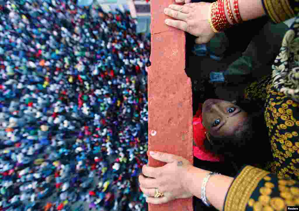 April 13: A child looks up during the Bisket festival at the ancient city of Bhaktapur near Kathmandu. The nine-day festival takes place over the Nepalese New Year.