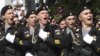 FILE - Russian servicemen march during the Victory Day military parade in Simferopol, Crimea, May 9, 2017. Russia annexed the Ukrainian peninsula in March 2014, fomenting a separatist rebellion in Ukraine's east weeks later. 