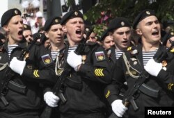 FILE - Russian servicemen march during the Victory Day military parade in Simferopol, Crimea, May 9, 2017.