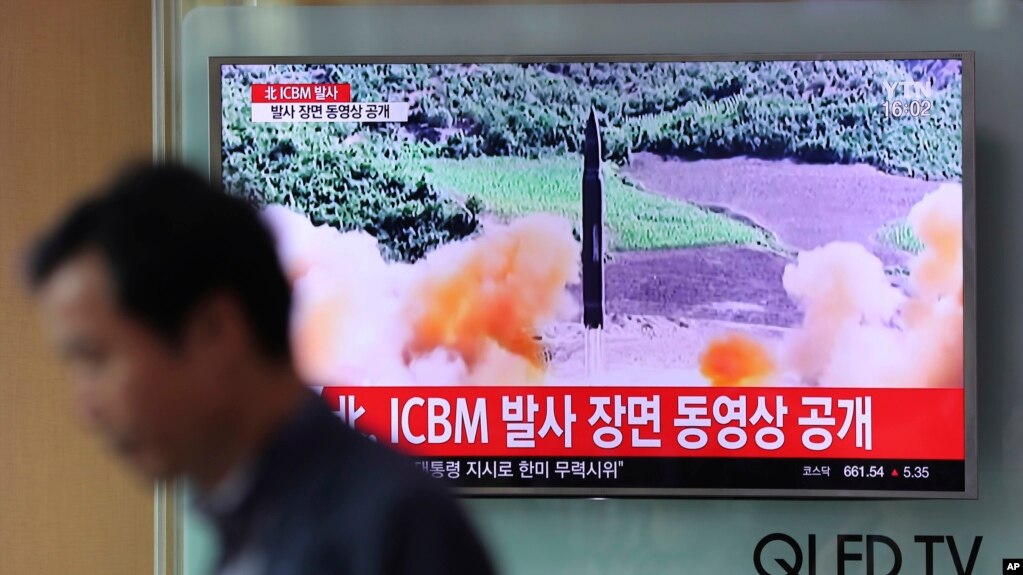 A man walks past a TV screen showing a local news program about North Korea's reported firing of an ICBM, at Seoul Train Station in Seoul, South Korea, July 5, 2017. North Korea’s newly demonstrated missile muscle puts Alaska within range of a potential attack. 