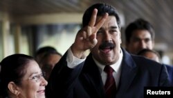 Venezuela's President Nicolas Maduro and his wife, Cilia Flores, arrive at the U.N. Human Rights Council for a special session in Geneva, Nov. 12, 2015.