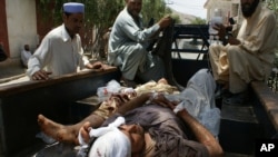 Pakistani villagers help victims from a blast to a district hospital in Landi Kotal Pakistan Afghanistan border, Saturday, June 16, 2012.