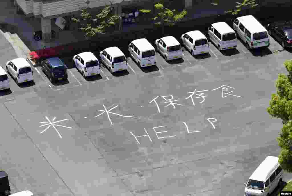 &quot;Rice, Water, Preserved Food and HELP&#39;&quot; written on the ground at a welfare center for the aged after an earthquake in Mifune town, Kumamoto prefecture, southern Japan, in this aerial view photo taken by Kyodo, April 17, 2016.