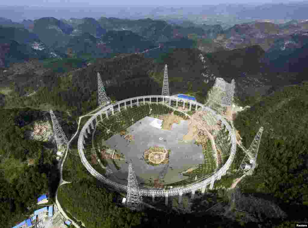 A 500-metre (1,640-ft.) aperture spherical telescope (FAST) is under construction in Pingtang county, Guizhou province, China, Nov. 26, 2015. The telescope, which will be the world&#39;s largest, will be put in use by Sept. 2016, according to local media.