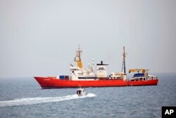 FILE - The rescue vessel 'Aquarius' approaches the Pozzallo harbor, southern Italy, June 1, 2018 .