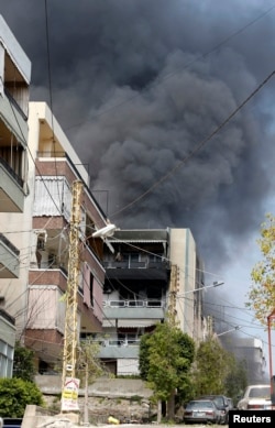 Smoke rises near a mosque complex, where hardline Sunni cleric Sheikh Ahmed al-Assir was believed to be sheltering with his supporters in Abra near Sidon, southern Lebanon, June 24, 2013.