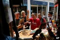 In this May 9, 2019 photo, Apa Sherpa, center, with members of his foundation walk around Boudhanath Stupa in Kathmandu, Nepal.