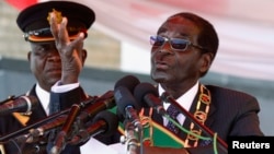 Zimbabwe's President Robert Mugabe addresses the crowd gathered to commemorate Heroes Day, in Harare, Zimbabwe, Aug. 12, 2013.