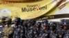 FILE - Policemen stand in front of an election banner of Uganda's President Yoweri Museveni in Kampala, Uganda, Feb. 15, 2016.