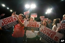 Supporters of Democratic senatorial candidate Doug Jones cheer as he comes onstage before he speaks during a "get out the vote rally," Dec. 9, 2017, in Birmingham, Ala.
