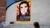 A woman walks near a poster asking for the freedom of Colombian businessman and Venezuelan special envoy Alex Saab, in Caracas, Venezuela, Oct. 16, 2021.