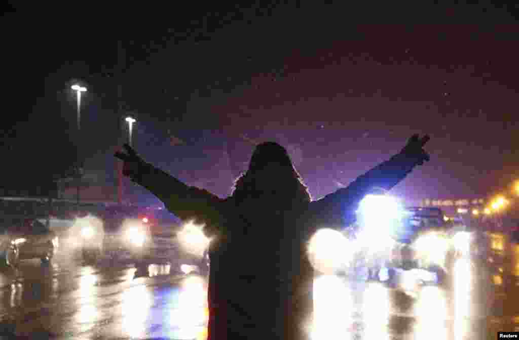 A protester walks in the street with his hands up after the grand jury verdict in the Michael Brown shooting in Ferguson, Missouri, Nov. 26, 2014.