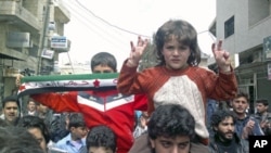 Demonstrators protest against Syria's President Bashar al-Assad in Kafranbel, near Idlib, Syria, April 1, 2012. 