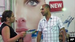 Wissem Abdennadher speaks to a potential customer at the Sfax business fair