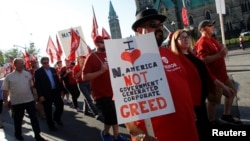 Members of Canada's Unifor union march past Parliament Hill during a rally ahead of the third round of NAFTA talks involving the United States, Mexico and Canada in Ottawa, Ontario, Sept. 22, 2017.