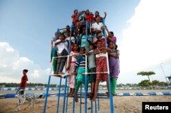 Children staying in the care home set up by Karibeeran Paramesvaran and his wife Choodamani pose in a park along a beach in Nagapattinam district in the southern state of Tamil Nadu, India.