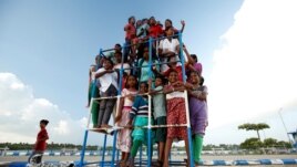 Children staying in the care home set up by Karibeeran Paramesvaran and his wife Choodamani pose in a park along a beach in Nagapattinam district in the southern state of Tamil Nadu, India.