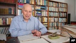 Manfred Steiner, who earned his Ph.D. in physics from Brown University at the age of 89, is photographed in his home office in East Providence, R.I., Wednesday, Nov. 10, 2021. (AP Photo/Stew Milne)
