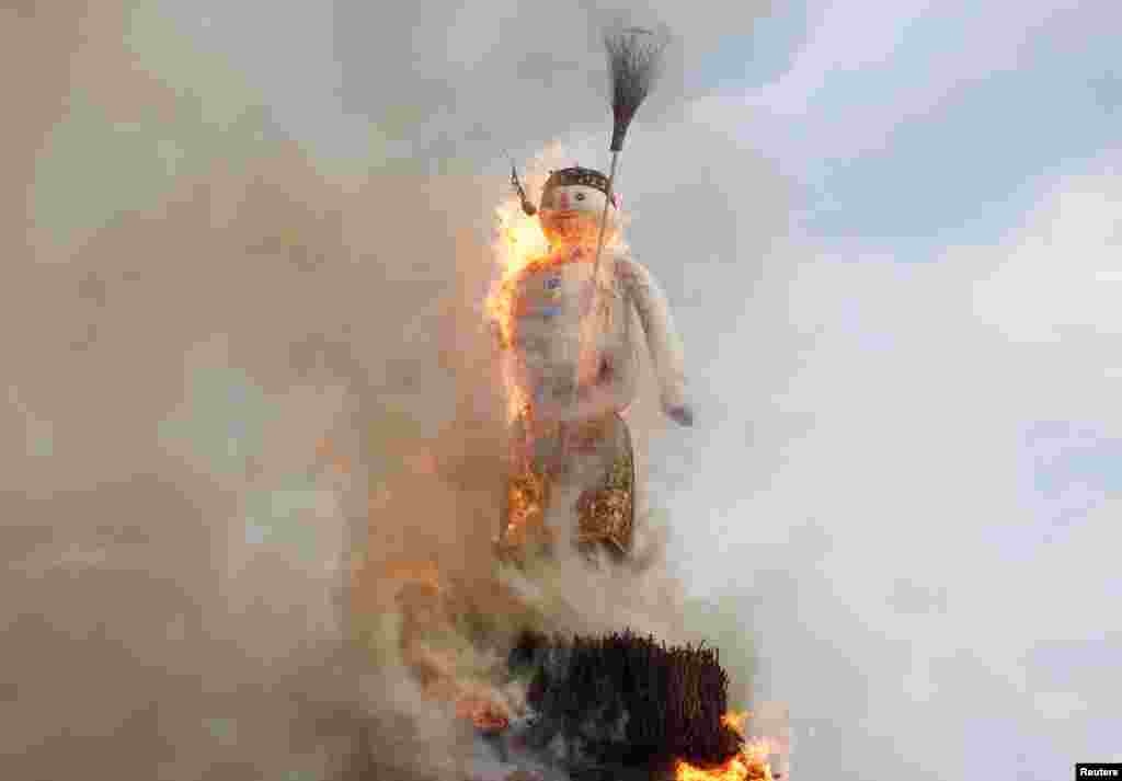 The Boeoegg, a snowman made of wadding and filled with firecrackers, is burning in a bonfire in the Sechselaeuten square in Zurich, Switzerland, April 8, 2019.