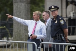 Boston Police Commissioner William Evans, left, with other officers along barricades on the Boston Common where a "Free Speech" rally is scheduled and a large rally against hate in solidarity with victims of Charlotestville will converge on Aug.18, 2017 i