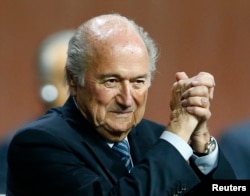 FILE - FIFA President Sepp Blatter gestures after he was re-elected at the 65th FIFA Congress in Zurich, Switzerland, May 29, 2015.