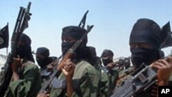 FILE: Islamist fighters loyal to Somalia's al-Qaida inspired al-Shebab group perform military drills at a village in Lower Shabelle region, some 25 kilometers outside Mogadishu. Taken 2.2011