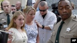 Mecklenburg County Sheriff's Deputies in North Carolina escort the family of Charlotte-Mecklenburg Police Officer Randall Kerrick from the courthouse following a mistrial in the Kerrick's trial, in Charlotte, N.C., Aug. 21, 2015.