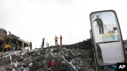 Workers and army personnel toil in the collapsed garment factory building in search for bodies, May 2, 2013 in Savar, near Dhaka, Bangladesh.