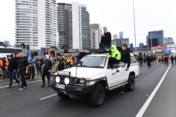 Construction workers and far right activists protest against coronavirus disease (COVID-19) restrictions on the West Gate Freeway in Melbourne, Australia, Sept. 21, 2021.