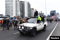 Construction workers and far right activists protest against coronavirus disease (COVID-19) restrictions on the West Gate Freeway in Melbourne, Australia, Sept. 21, 2021.