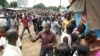 A September 28, 2009 photo shows Guinean demonstrators fleeing as security forces disperse them from outside the stadium where tens of thousands gathered for a pro-democracy rally, in Conakry. Security forces loyal to the ruling military junta opened fire on the crowd that day, killing at least 157 and raping dozens of women. 