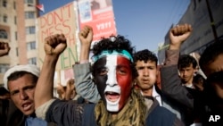 FILE - A Houthi Shi'ite rebel with Yemen's flag painted on his face chants slogans during a rally in the capital, Sana'a. (File)