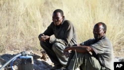 Two men from Kikao wait for water at the Mothomelo borehole