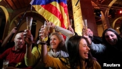 People react to results in Catalonia's regional elections at a gathering of the Catalan National Assembly in Barcelona, Spain, Dec. 21, 2017. 