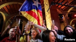 People react to results in Catalonia's regional elections at a gathering of the Catalan National Assembly in Barcelona, Spain, Dec. 21, 2017. 