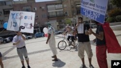 Israelis wave banners calling for peace during a rally for love outside the Egyptian Embassy in Tel Aviv, Israel, September 16, 2011. 