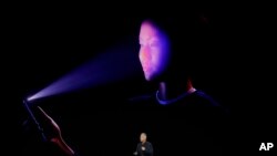 Phil Schiller, Apple's senior vice president of worldwide marketing, announces features of the new iPhone X at the Steve Jobs Theater on the new Apple campus on Tuesday, Sept. 12, 2017, in Cupertino, Calif. (AP Photo/Marcio Jose Sanchez)