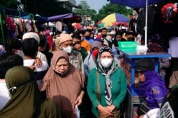 Sejumlah perempuan mengenakan masker pelindung berbelanja di pasar jalan Gasibu di tengah pandemi COVID-19 di Bandung, Jawa Barat, 31 Oktober 2021. (Foto: Reuters)