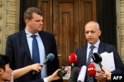 Gabor Elo, left, and Balazs Toth, attorneys for the ship captain charged in a fatal accident on the Danube, talk to reporters in front of the Budapest Court, June 1, 2019.