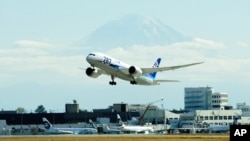 FILE - The first scheduled Boeing 787 airplane to depart from Seattle-Tacoma International Airport, takes off October 2, 2012. 