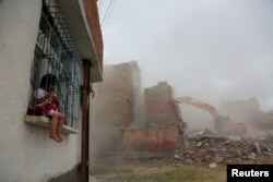 An excavator wrecks a building as part of an urban transformation project in Sur neighborhood in the Kurdish-dominated southeastern city of Diyarbakir, Turkey, May 23, 2017.