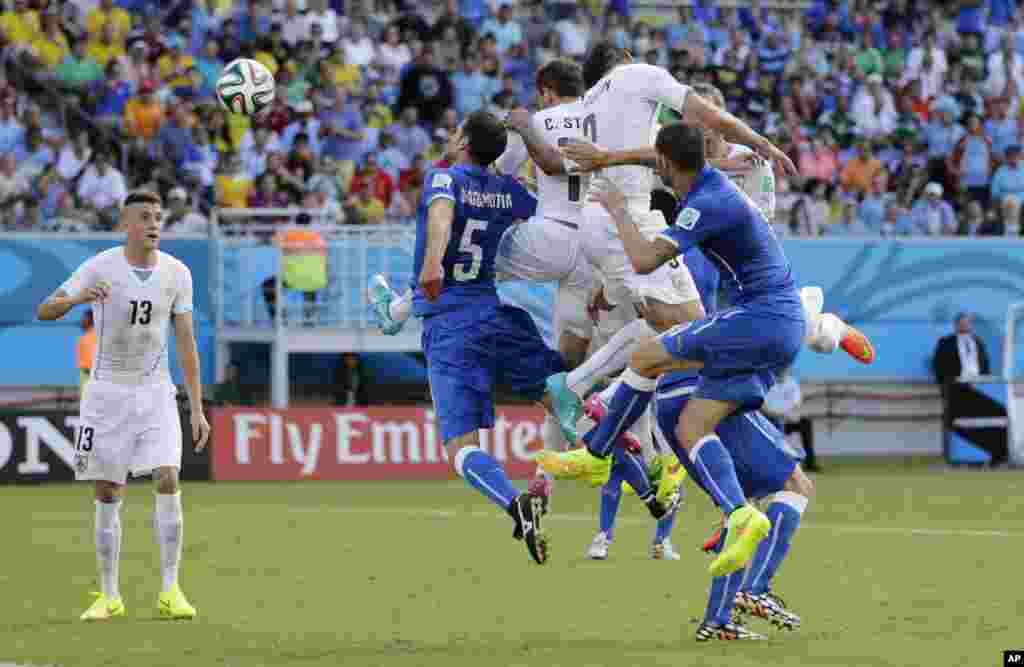 Uruguay&#39;s Diego Godin, second right, scores with a header against Italy in the World Cup match at the Arena das Dunas in Natal, Brazil.