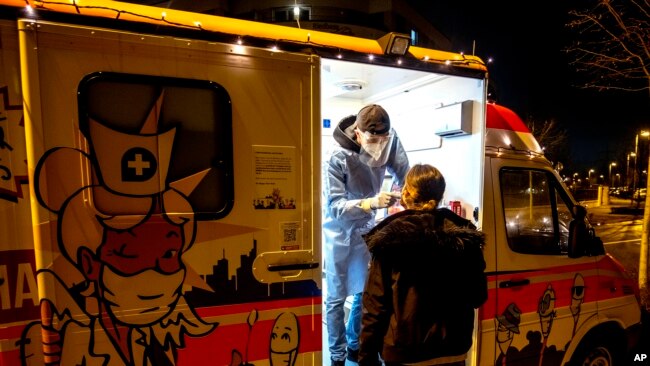 A woman is tested at a mobile Covid-19 test station in Frankfurt, Germany, Jan. 17, 2022.